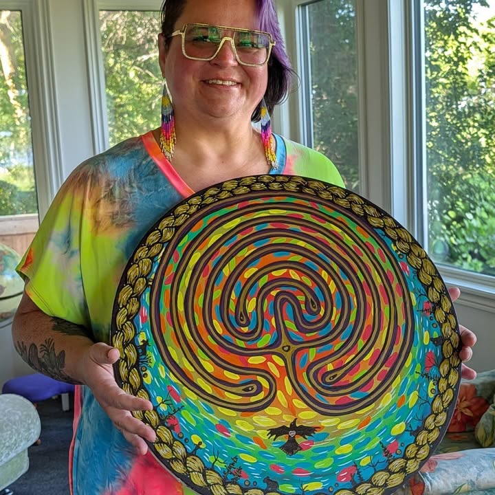 A student holds a piece of artwork