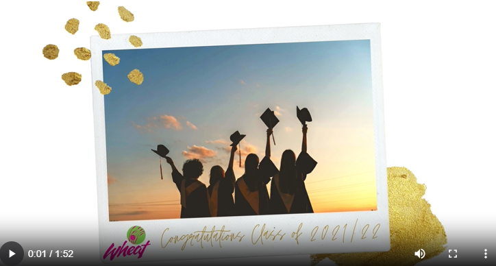 Four people holding up their graduation caps and certificates.