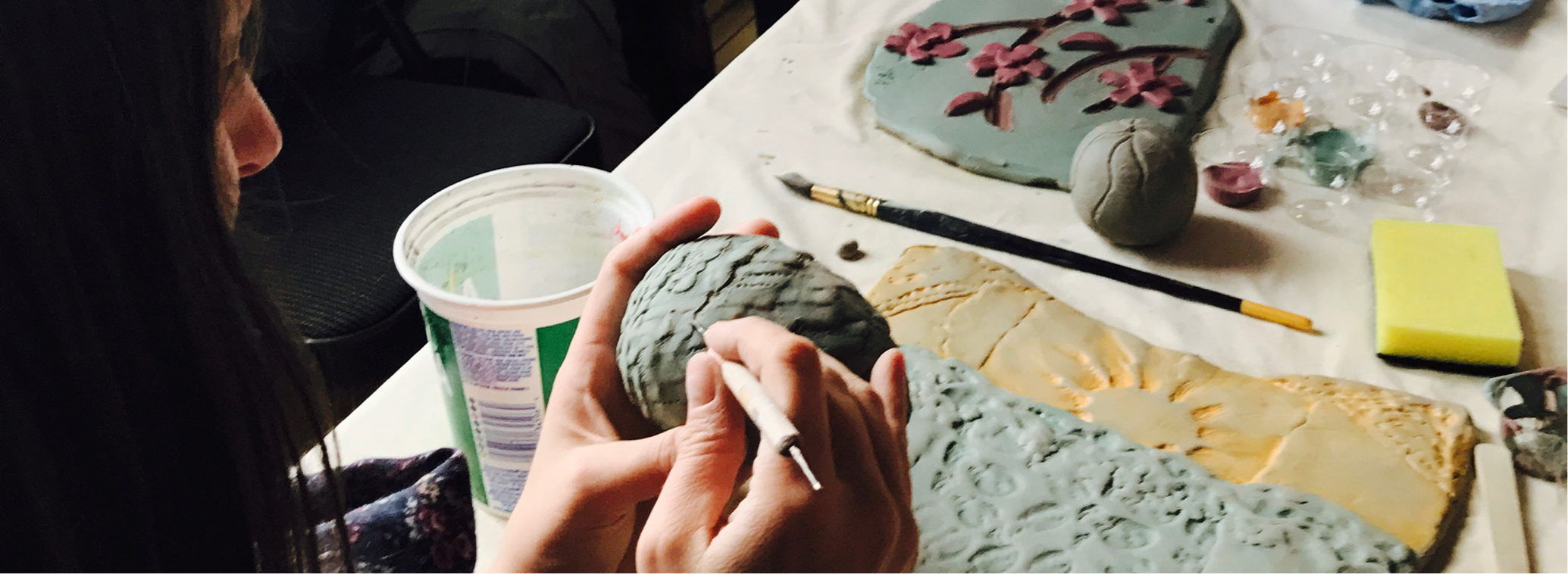 Person working with clay carving.