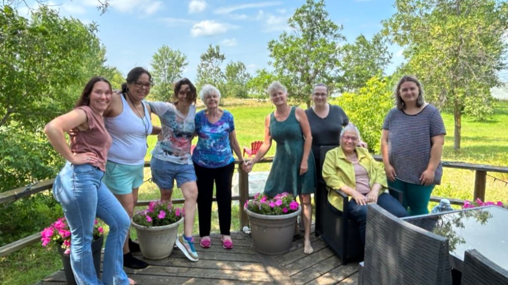 Group of people standing on deck.