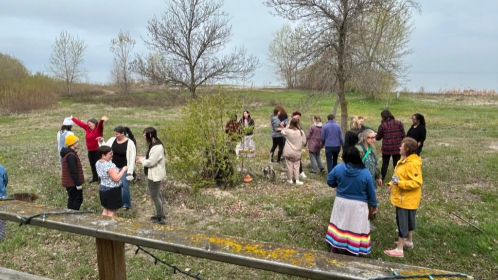 Group of people standing in yard.