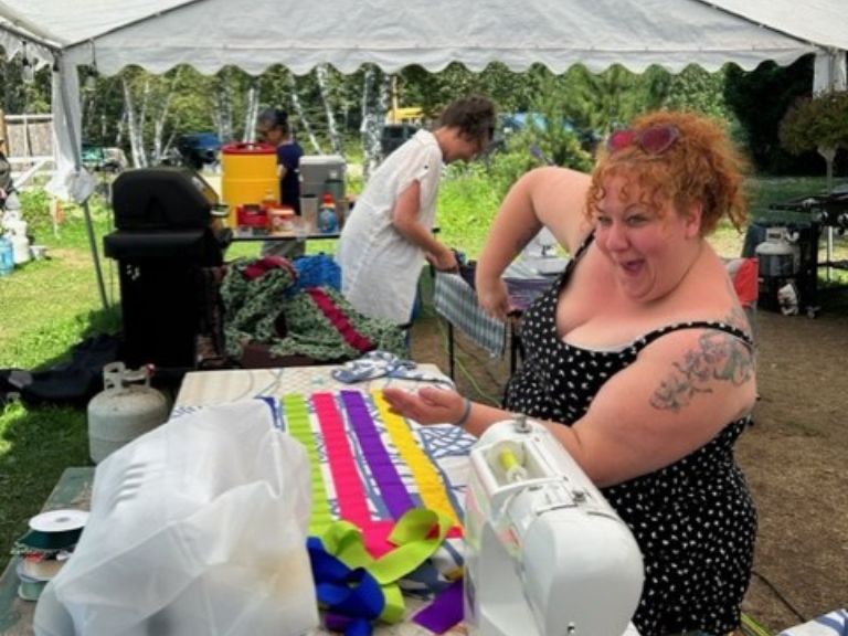 Person working on a ribbon skirt.