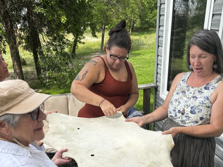Group of people stretching material.