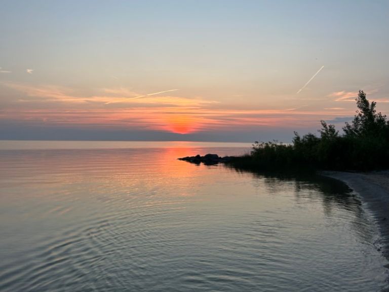 Sun setting over lake.