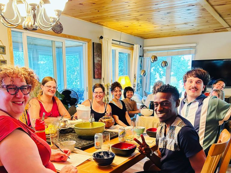 Group of people sitting around a table sharing a meal.