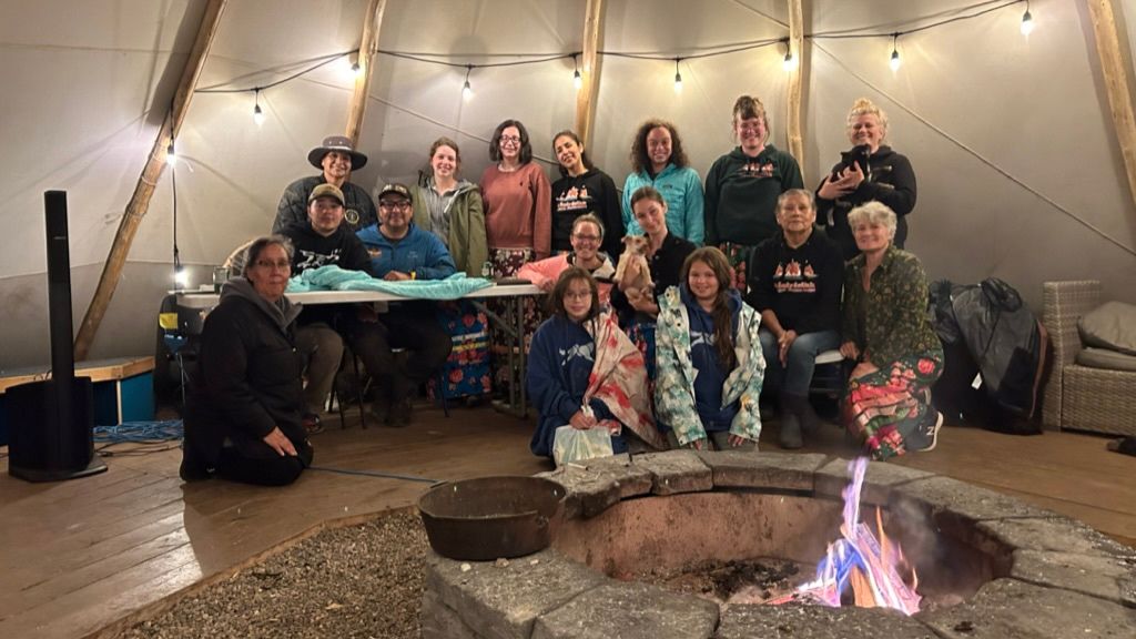 Group of people in a tipi.