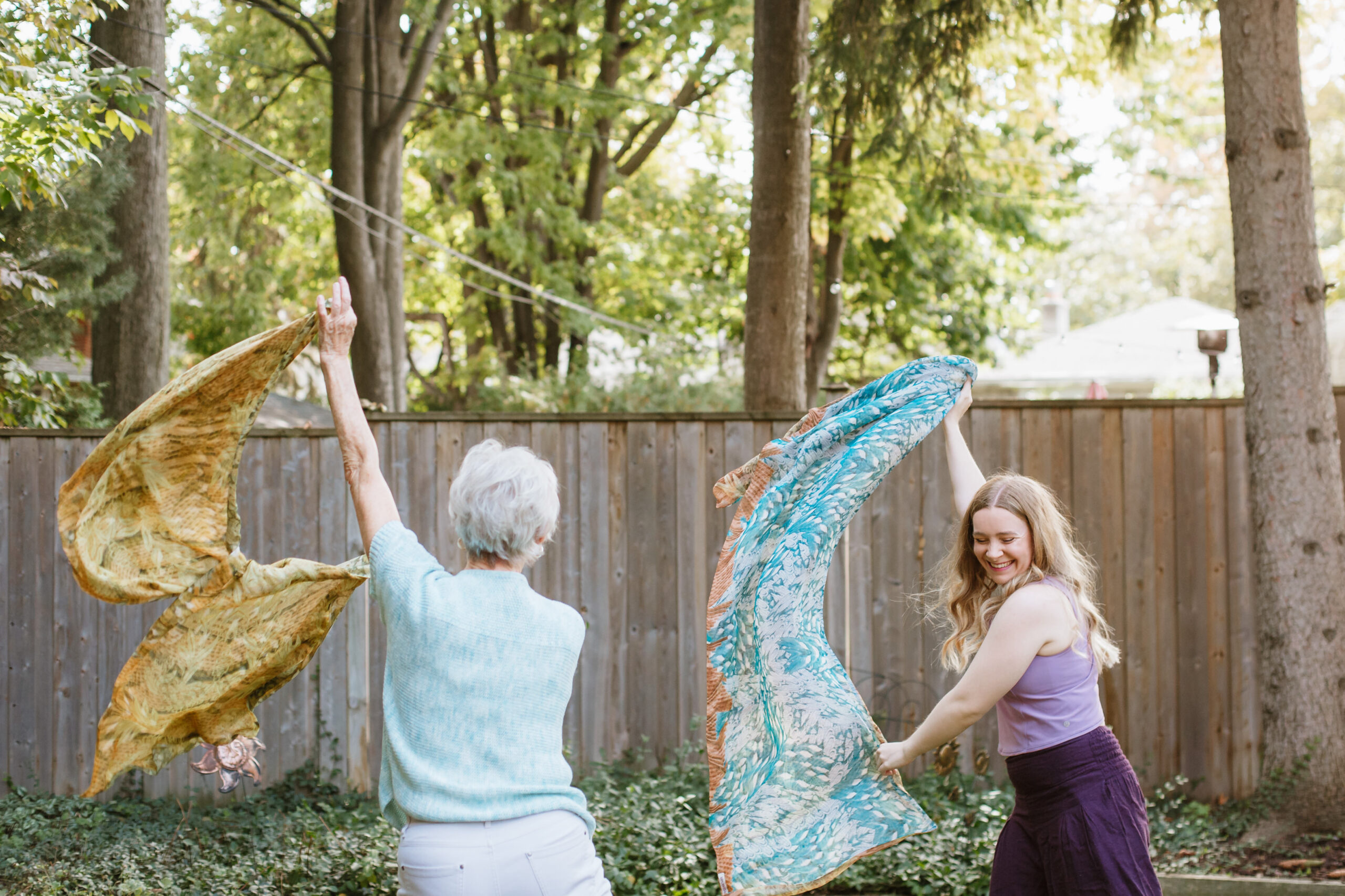 Two people dancing with fabric outside