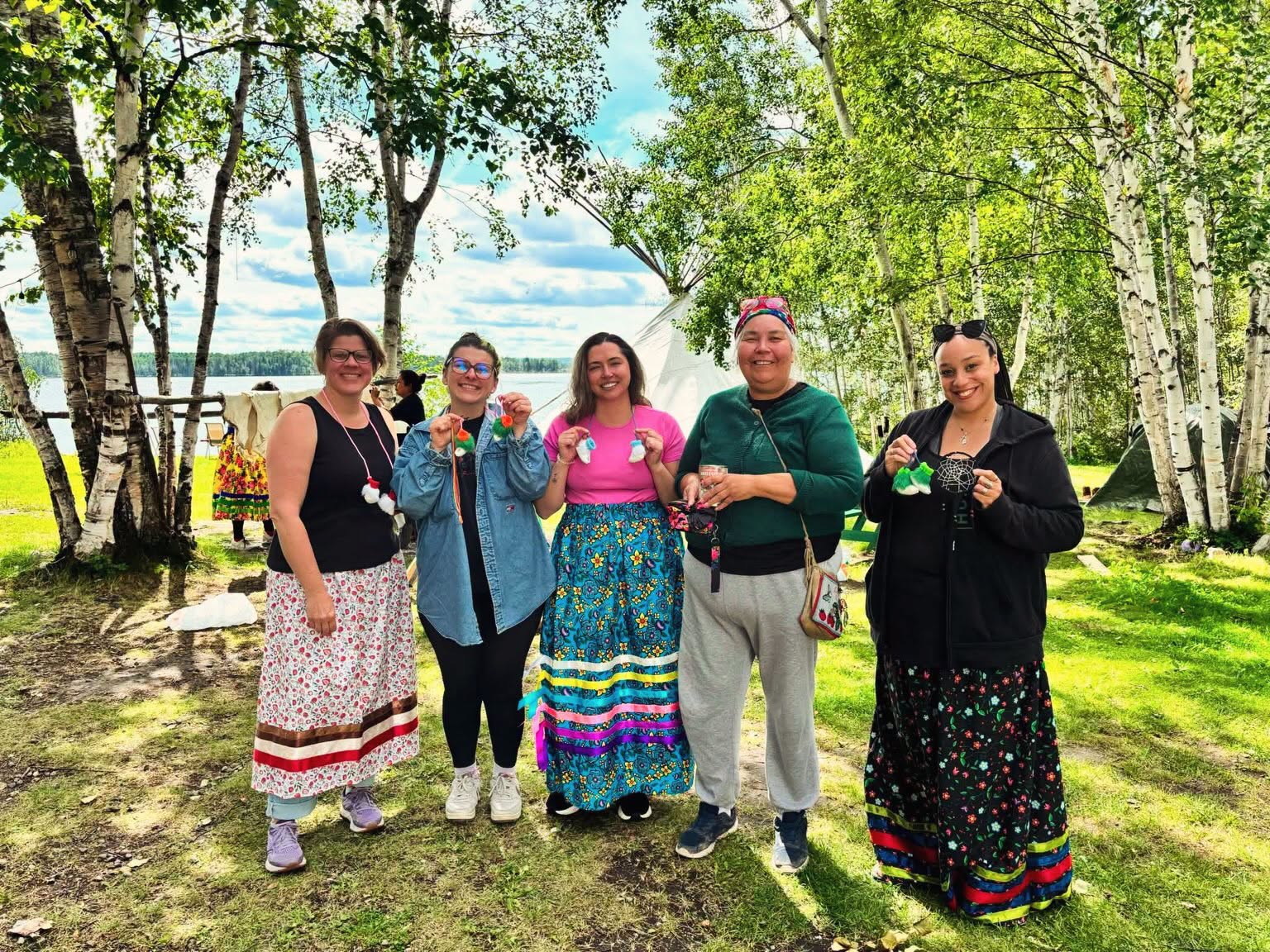 Group of students wearing their ribbon skirts at kâniyâsihk Culture Camp