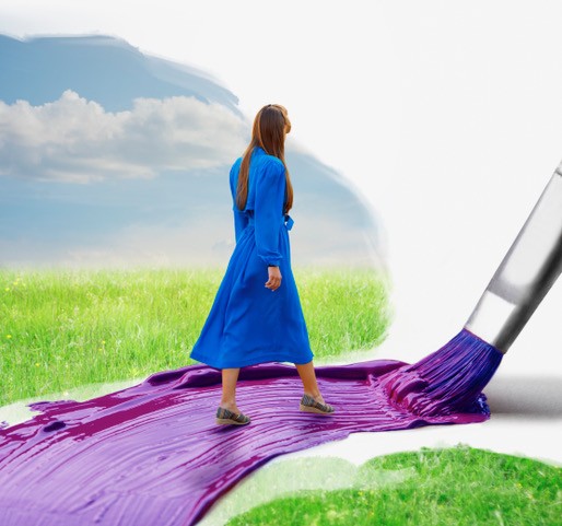 A woman wearing a blue dress is walking along a brush stroke of purple paint